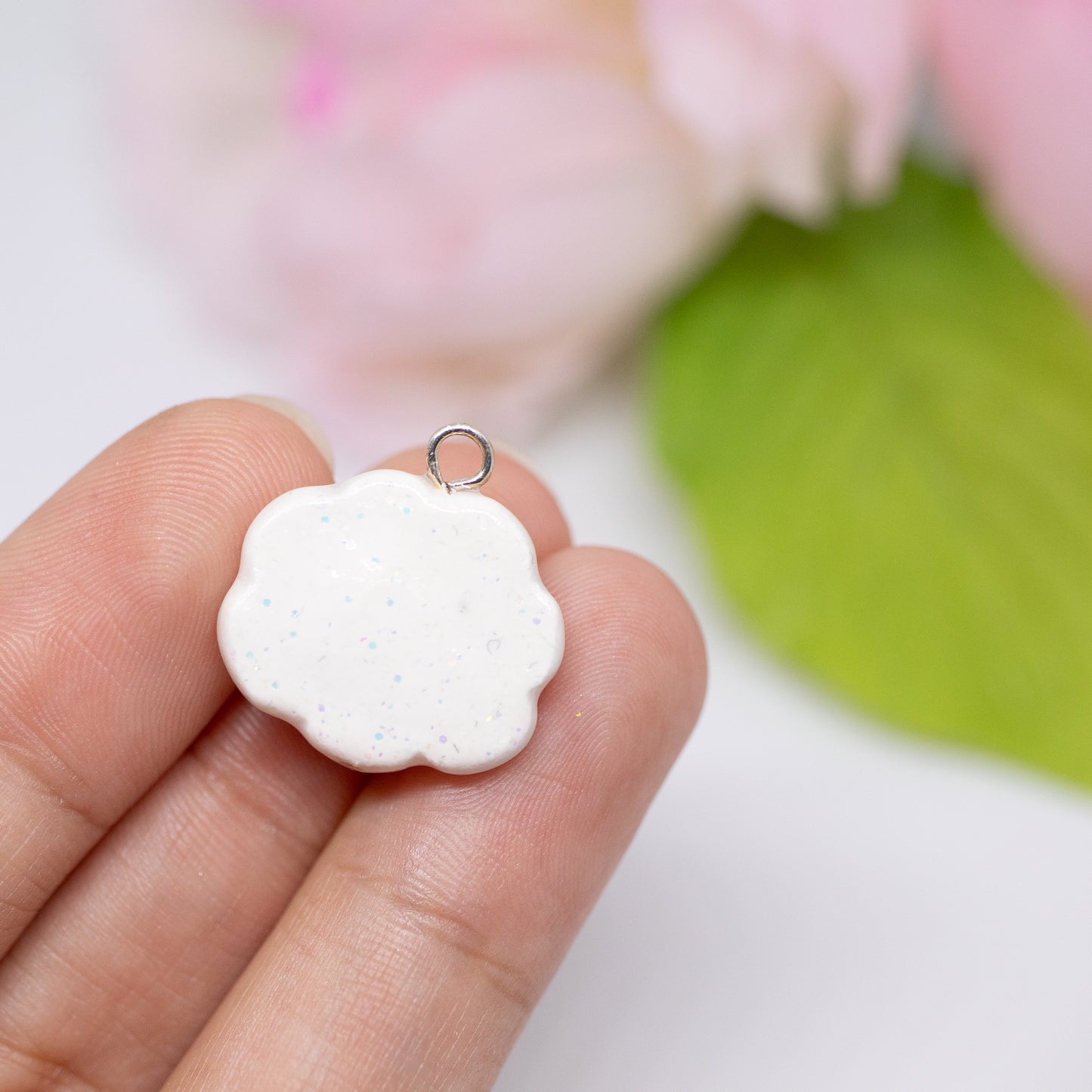 Handmade polymer clay aloha cloud charms. This cloud charm comes with a phone strap and spells out the word aloha in rainbow colors.