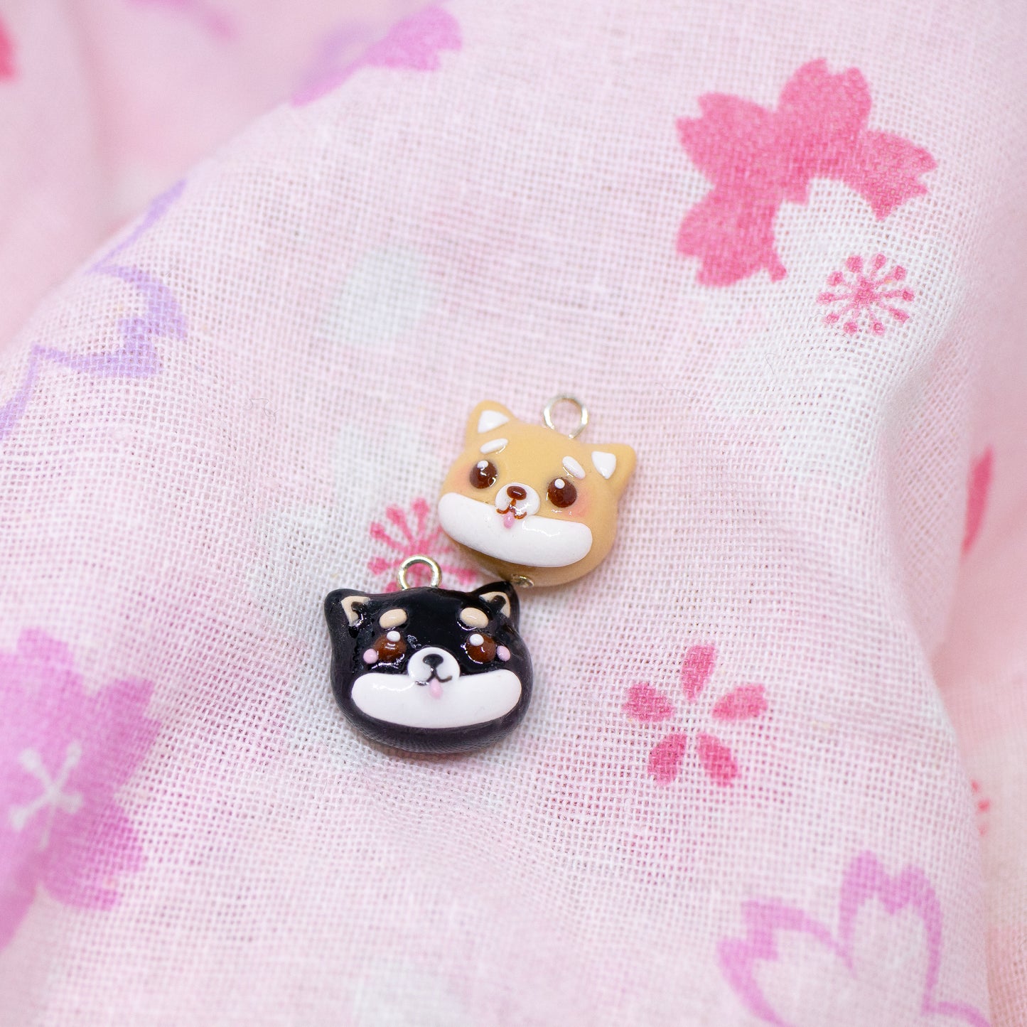 Handmade polymer clay shiba inu charms. Available in two colors: black and tan. Use as a charm or as a pair of earrings.