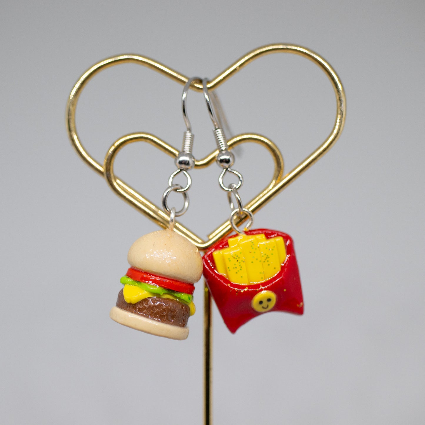 Handmade polymer clay burger and french fry charms. Available as a phone charm or pair of earrings. The perfect matching friendship charms for you and someone you love.