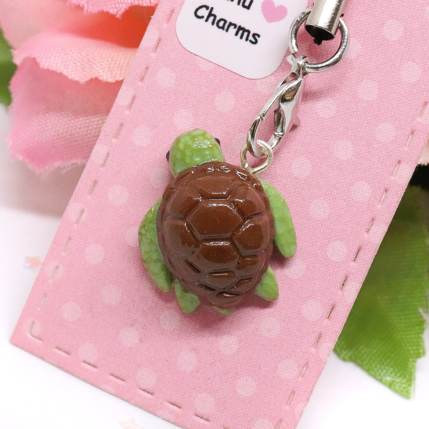 A little honu sea turtle charm. Handmade from polymer clay. It has a brown shell and fins that are textured for a realistic effect.