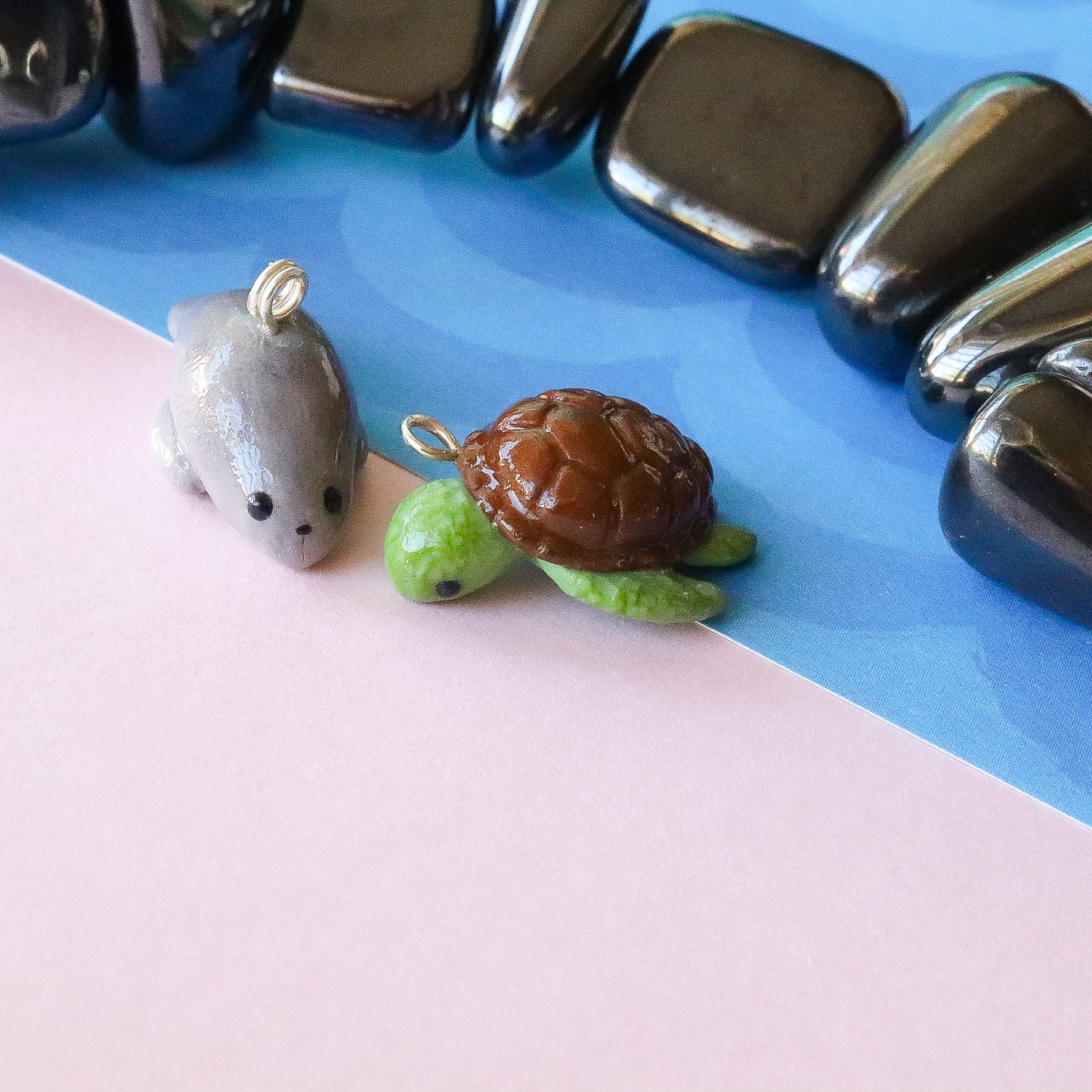 A little honu sea turtle charm. Handmade from polymer clay. It has a brown shell and fins that are textured for a realistic effect.