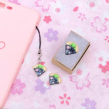 Load image into Gallery viewer, A simple alien pizza charm. This little charm has a tiny, green alien tucked inside a pizza. The pizza is galaxy-themed, with little planets, stars and glitter. This charm can be attached onto a cellphone, planner or purse!
