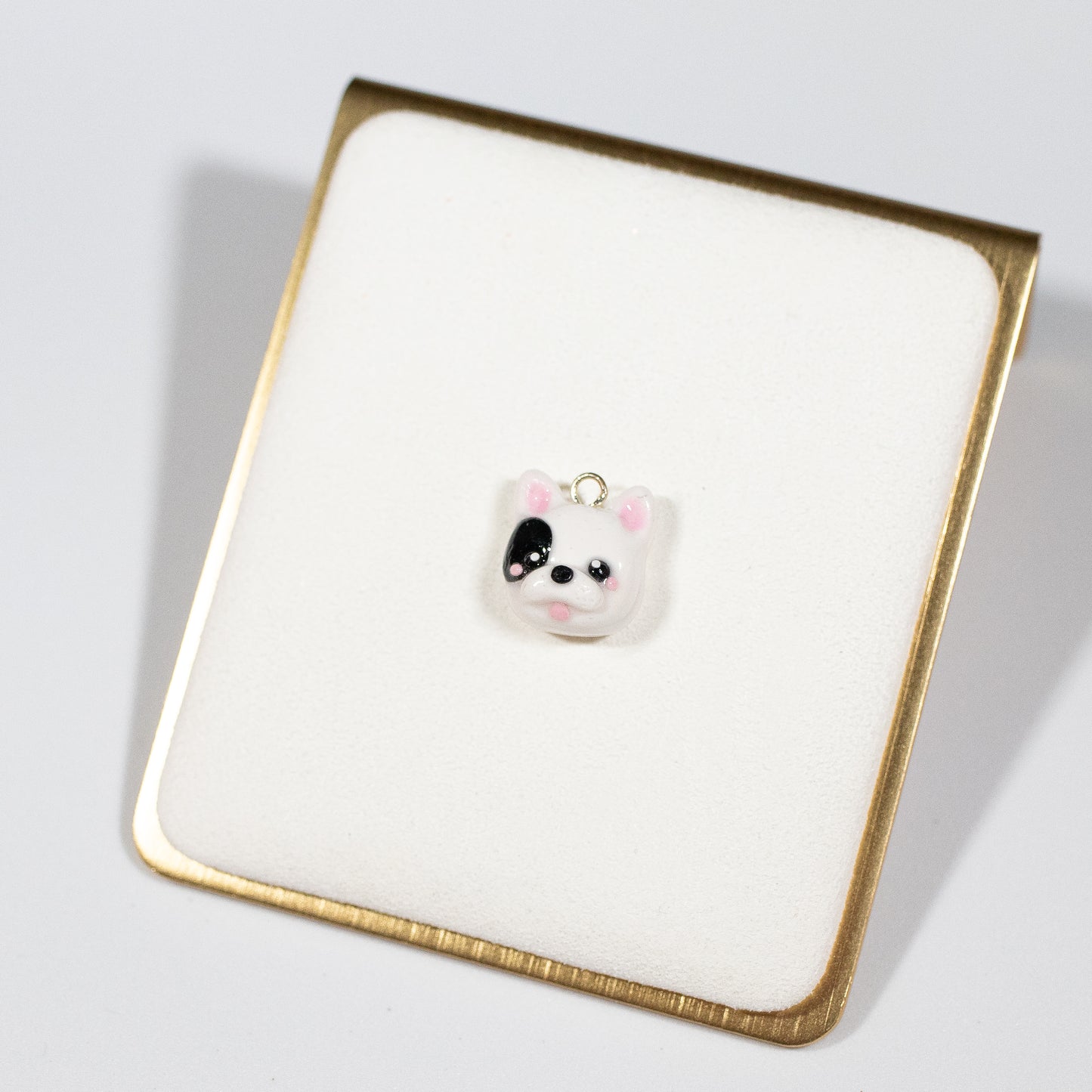 Cute and simple French bulldog charms! These little doggies have little blushing cheeks and a tongue that sticks out. Available in two colors: tan and black/white. Handmade from polymer clay, glazed with resin. A complimentary phone strap is included. Charm can be attached to a cell phone, purse, stitch marker, earrings, and more!