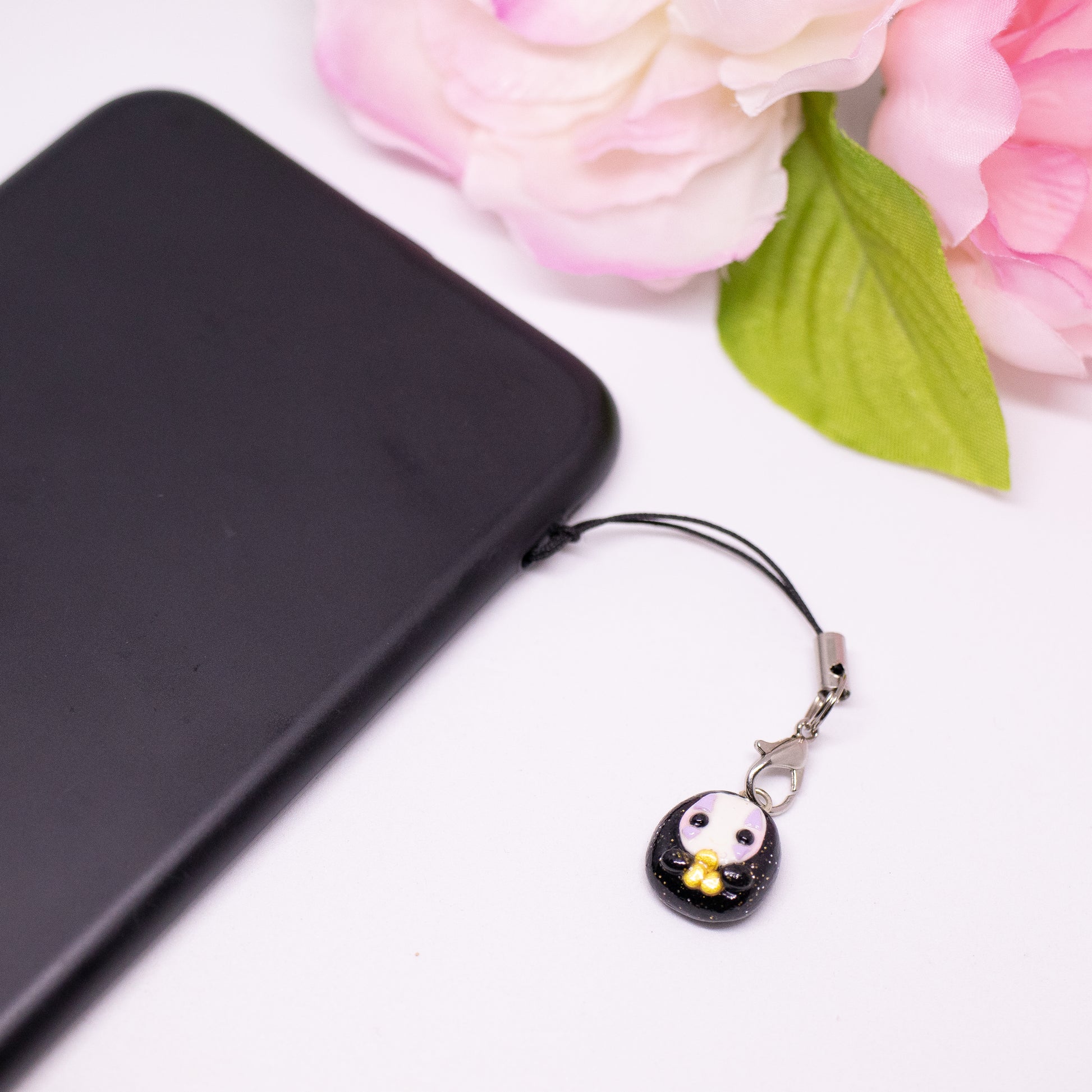 Handmade polymer clay no face charm inspired by the movie spirited away. The no face is holding little gold coins in it's hands.