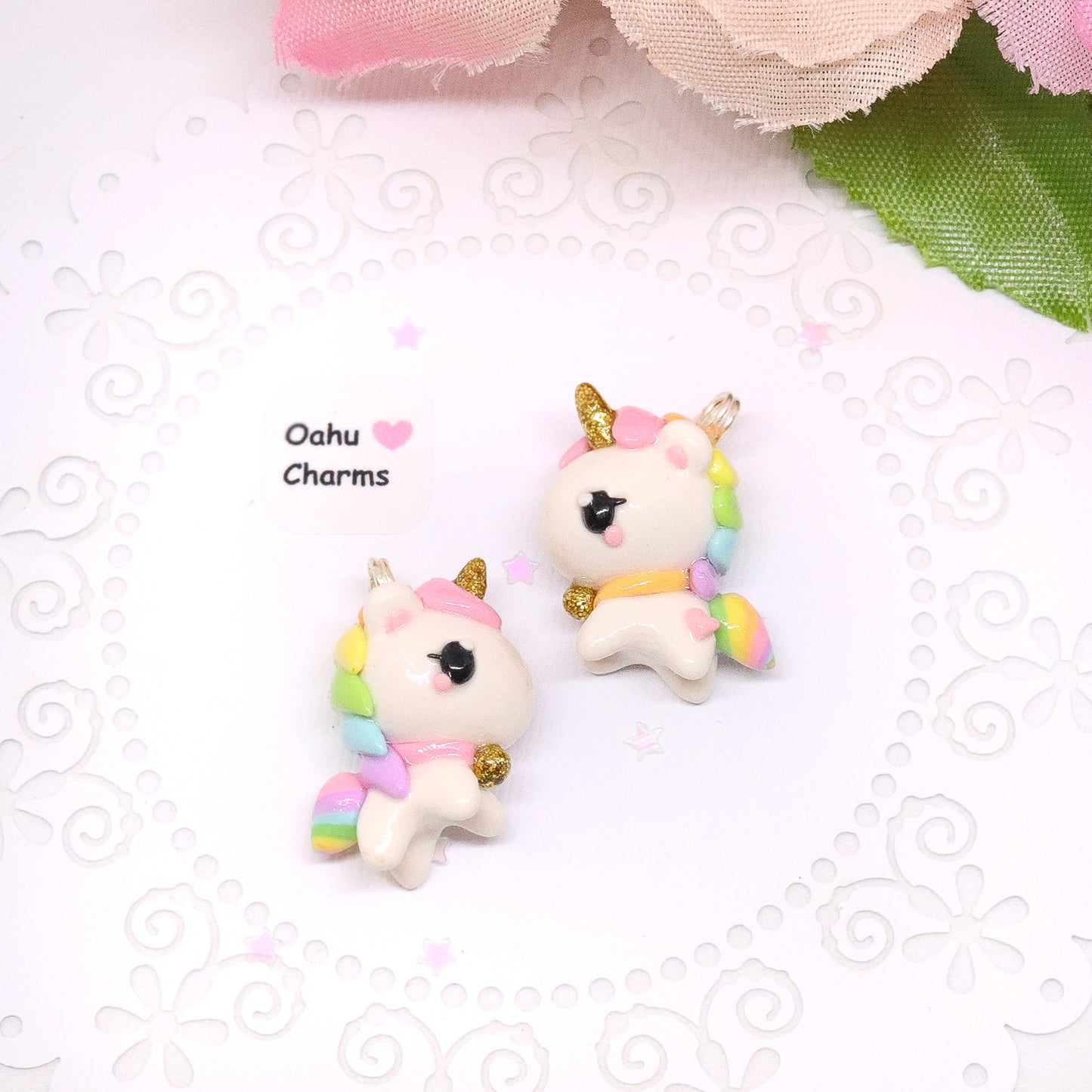 A chubby, rainbow unicorn with a gold bell and unicorn horn. They can be used as phone charms, earrings or planner charms!
