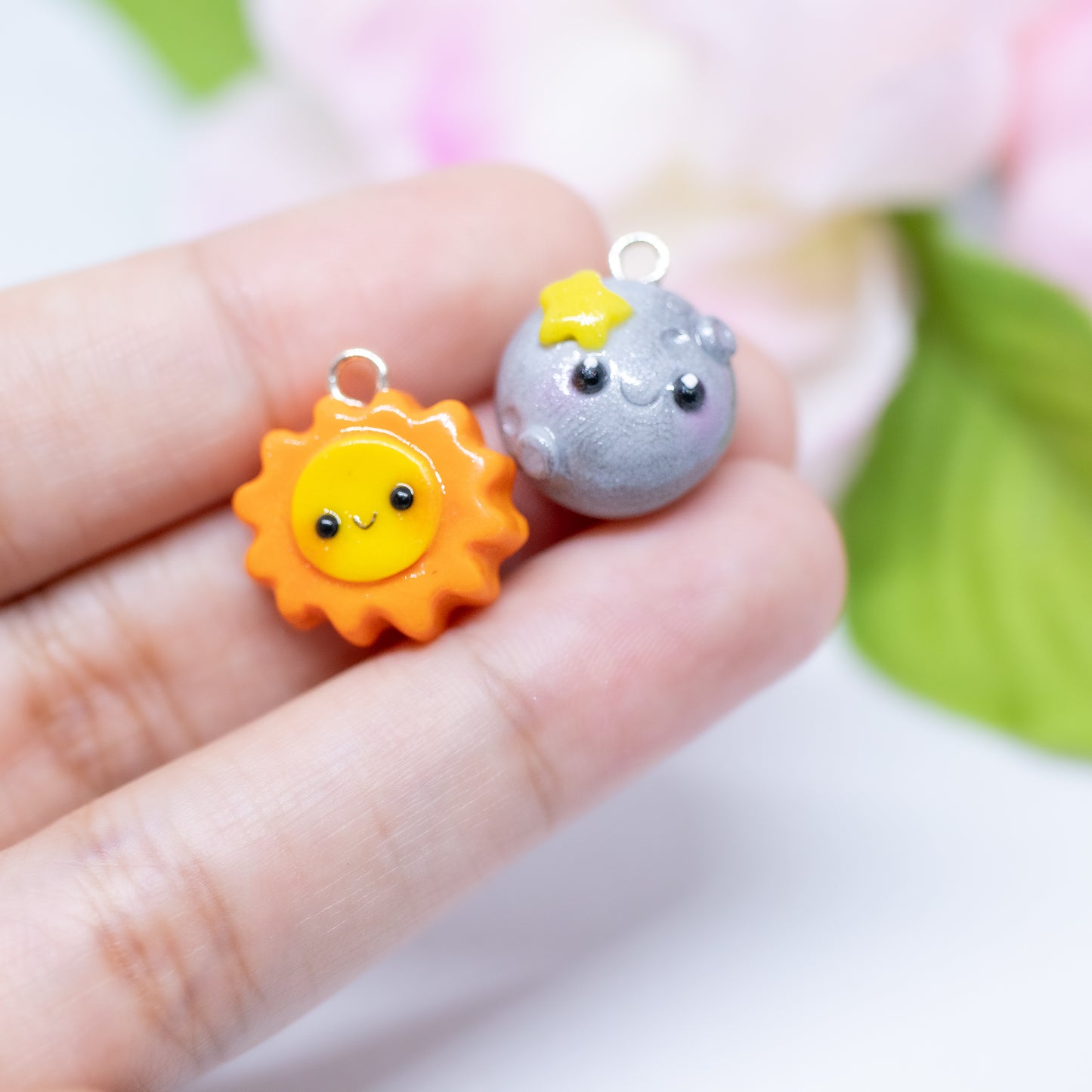 Our sun and moon clay charms on phone cases. These matching charms both have cute happy faces and pink blush.