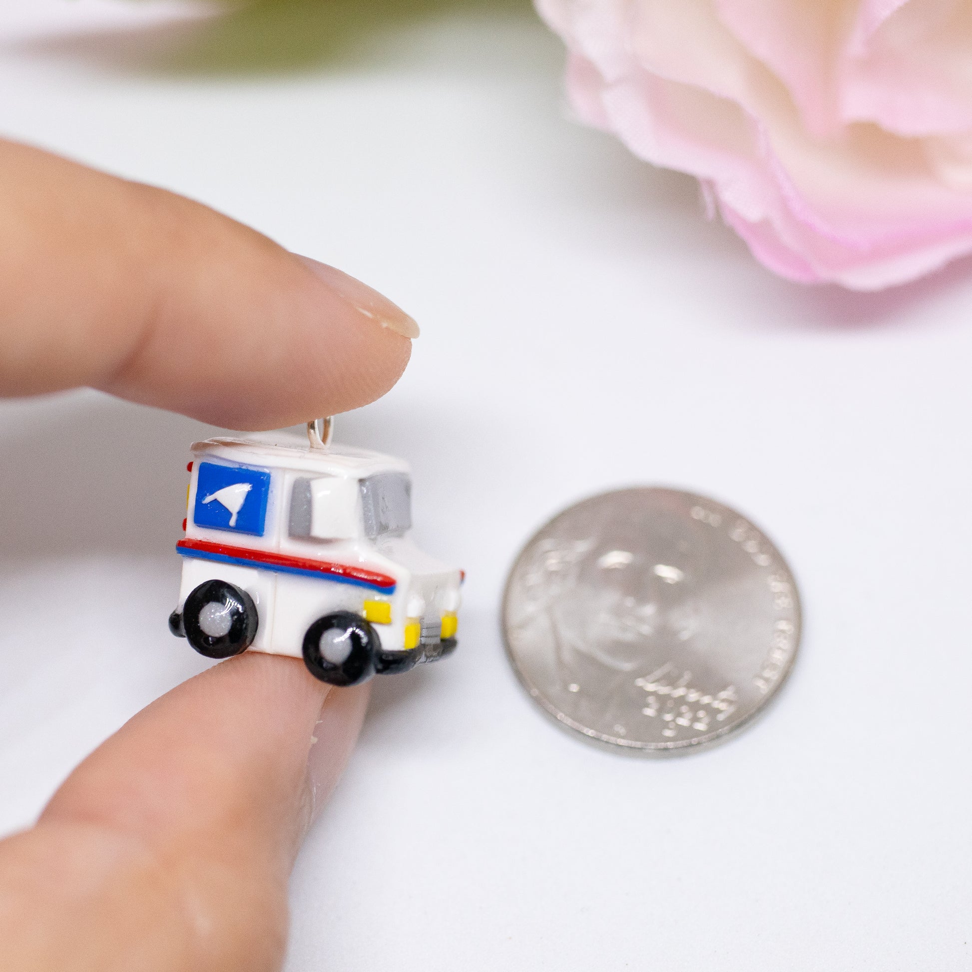 A tiny charm replica of an all too familiar truck that we see every day. Inspired by the USPS, this kawaii postal truck is boxy and cute with details on each side!