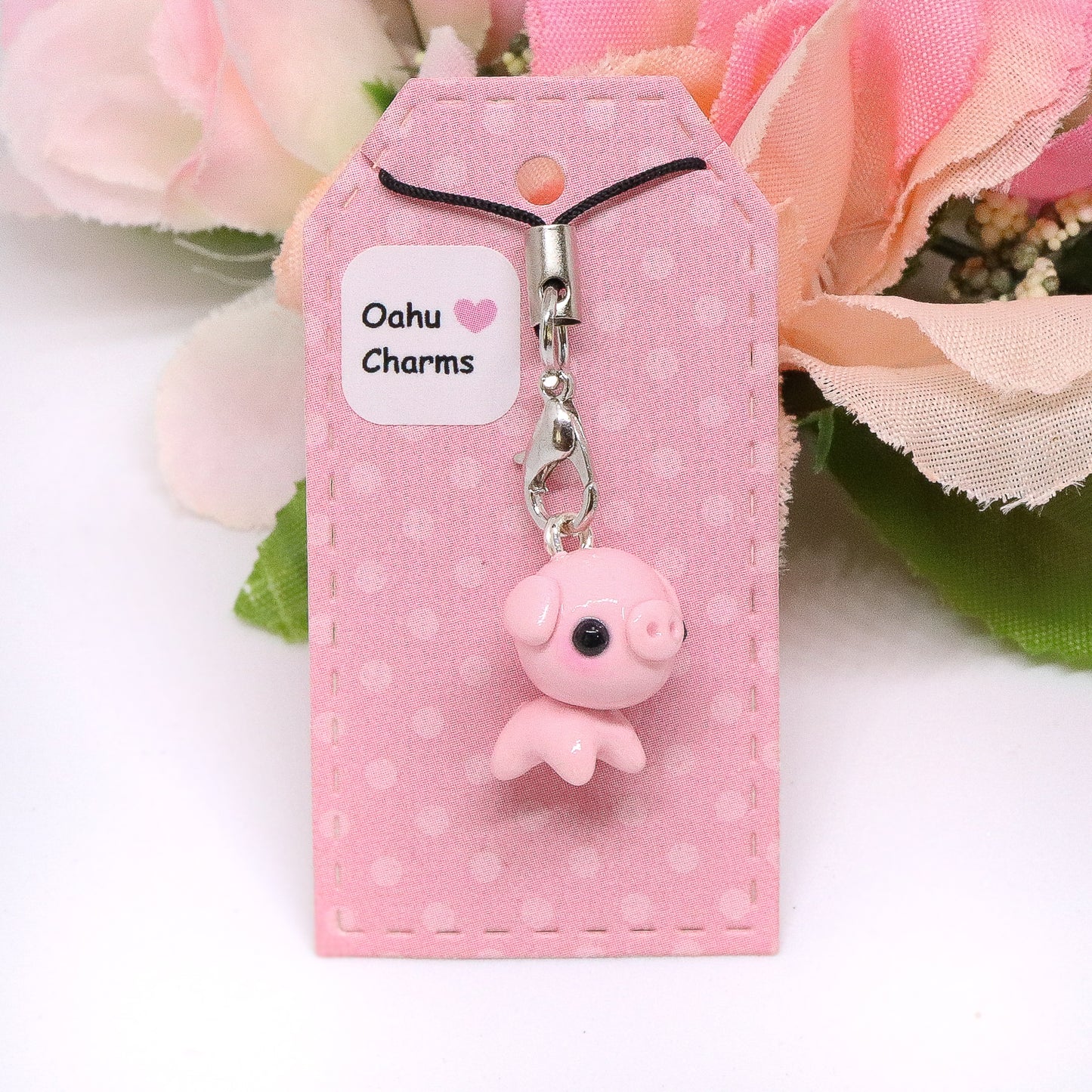 A cute, chubby pig charm. This charm has a lot of tiny details, including a snout and curly tail. Size: 0.75" wide x 0.75" tall