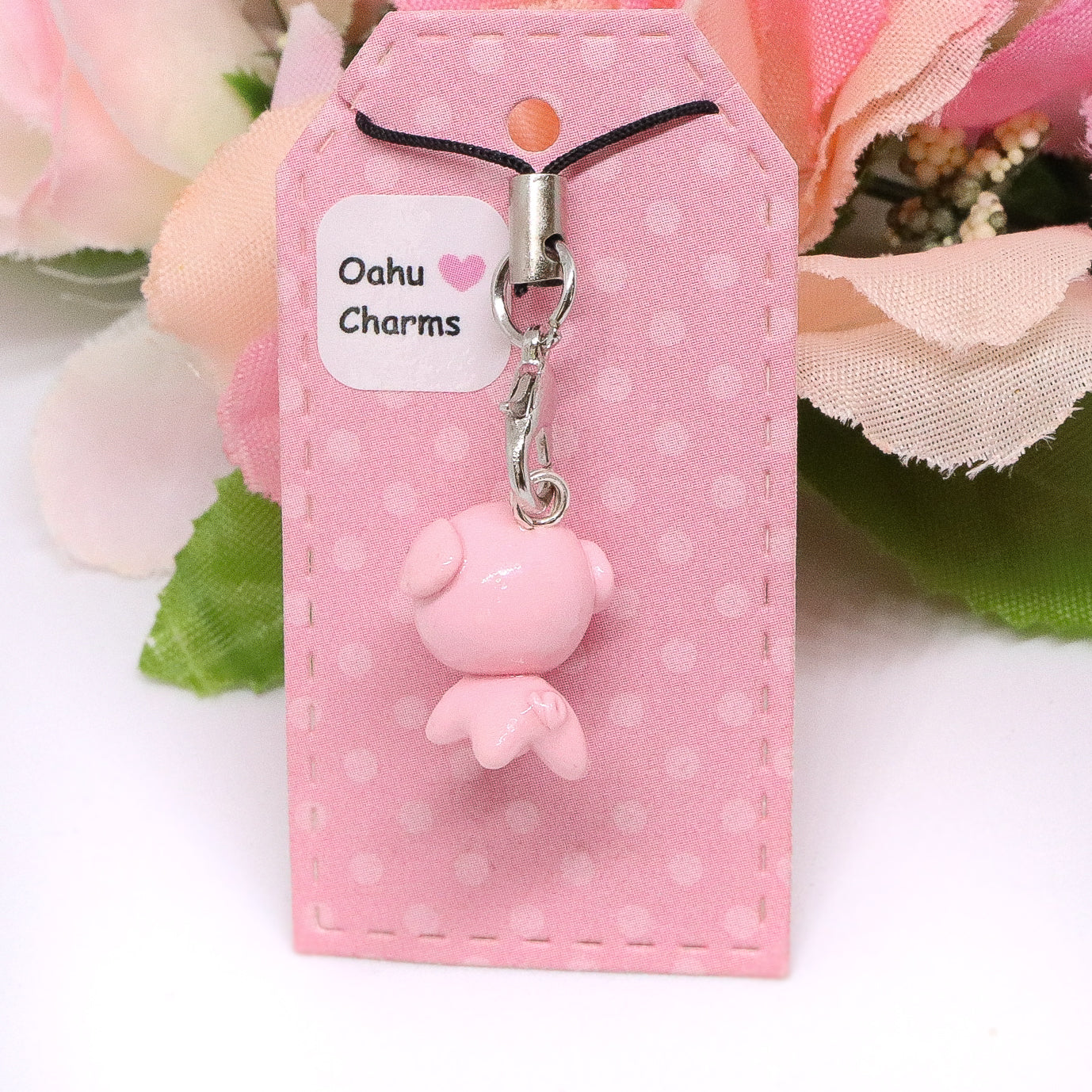 A cute, chubby pig charm. This charm has a lot of tiny details, including a snout and curly tail. Size: 0.75" wide x 0.75" tall