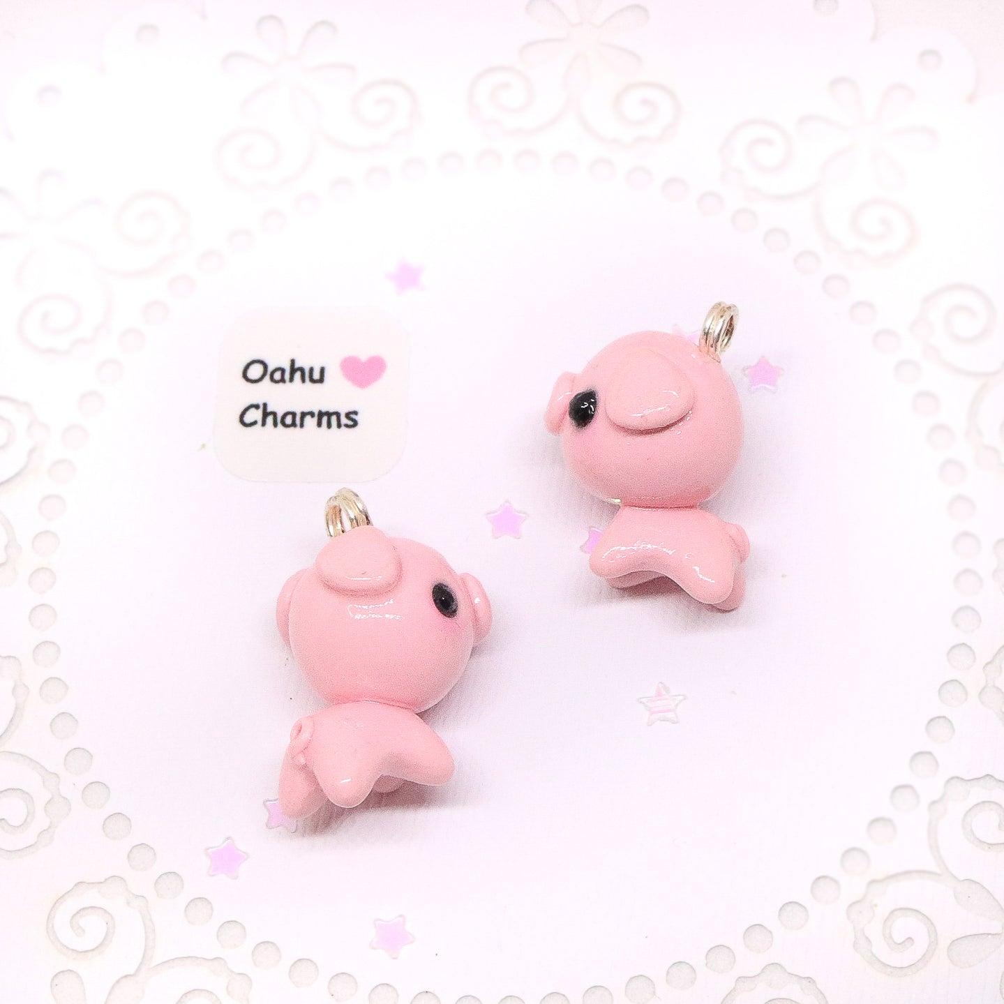 A cute, chubby pig charm. This charm has a lot of tiny details, including a snout and curly tail. Size: 0.75" wide x 0.75" tall