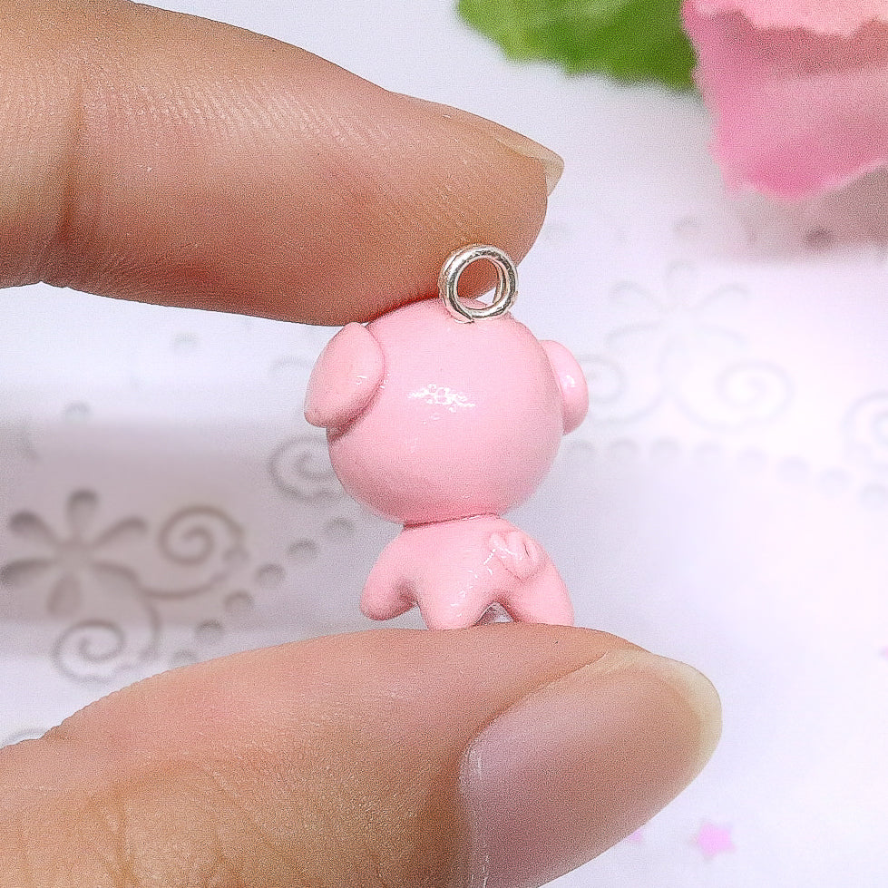 A cute, chubby pig charm. This charm has a lot of tiny details, including a snout and curly tail. Size: 0.75" wide x 0.75" tall
