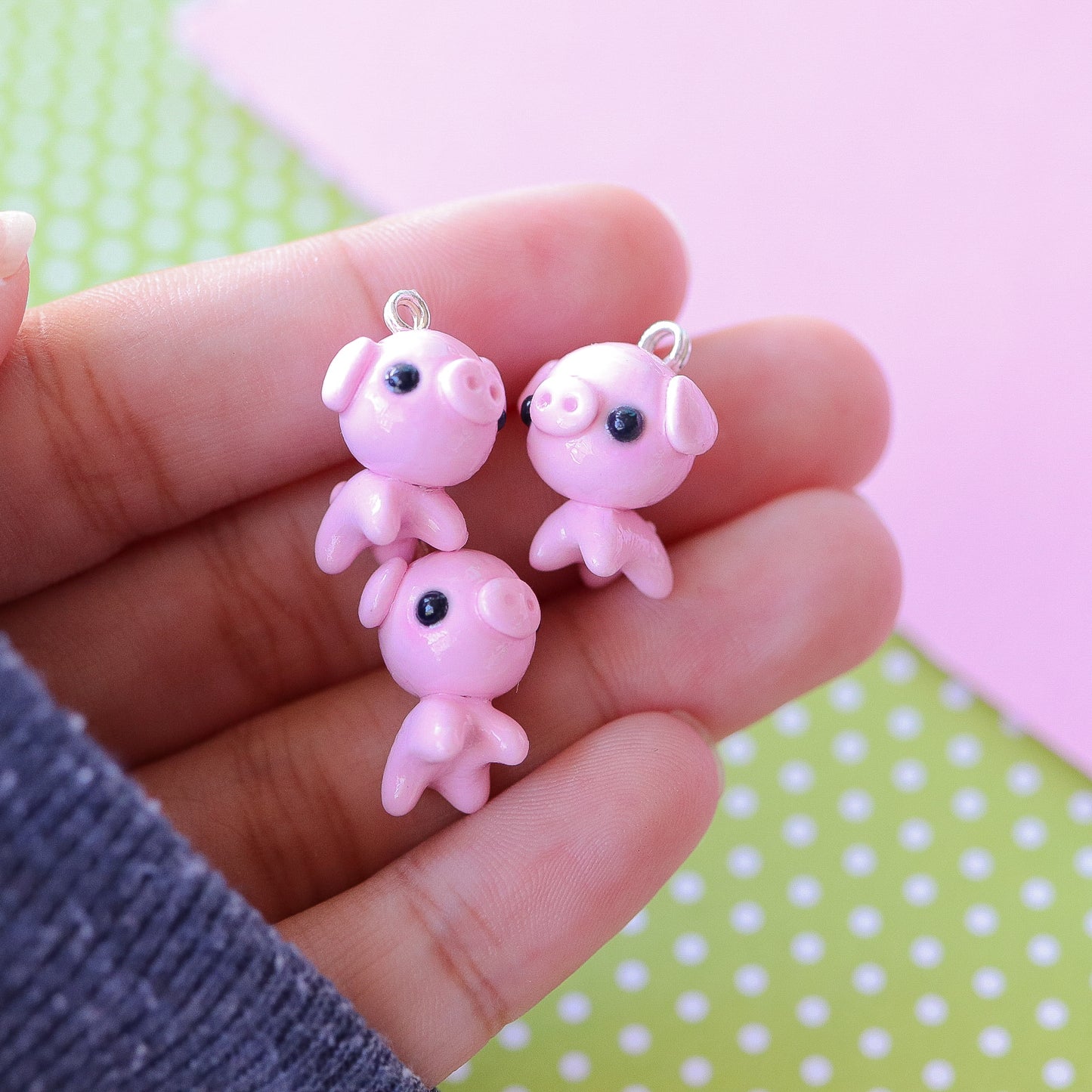 A cute, chubby pig charm. This charm has a lot of tiny details, including a snout and curly tail. Size: 0.75" wide x 0.75" tall