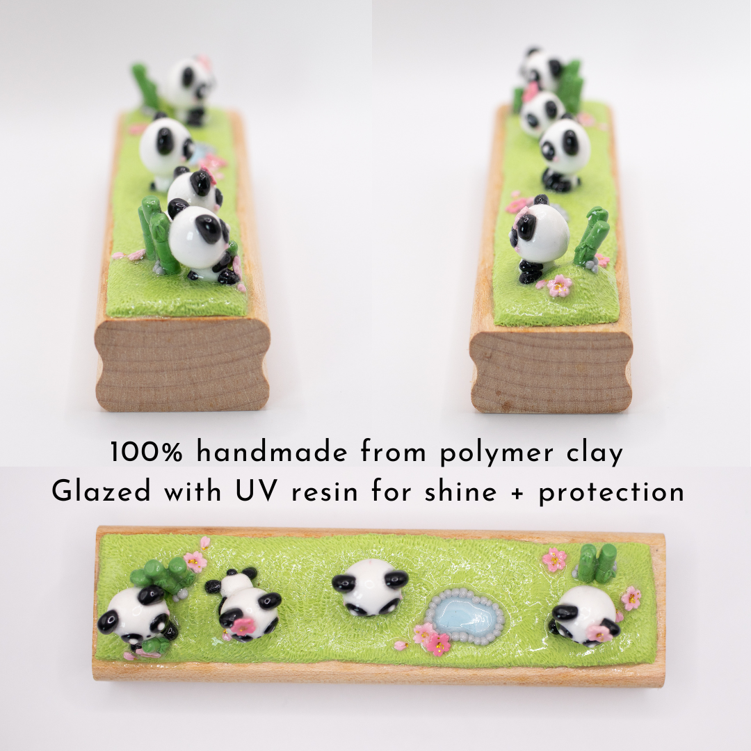 A picture showing three different anges of a small wood block figurine with panda decorations on a white background. The text on this image says "100% handmade from polymer clay, glazed with UV resin for shine + protection"