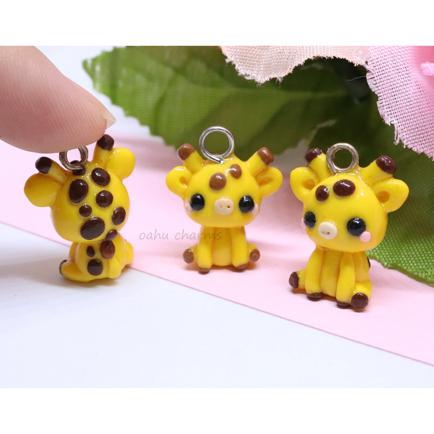 A cute, chubby giraffe that sits up on it's own. It has lots of brown spots, pink blush, and little ears. Handmade from polymer clay.