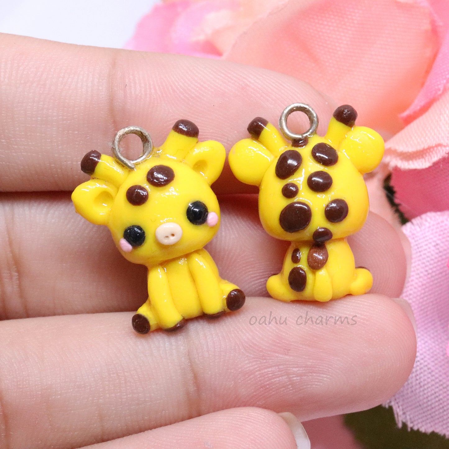 A cute, chubby giraffe that sits up on it's own. It has lots of brown spots, pink blush, and little ears. Handmade from polymer clay.