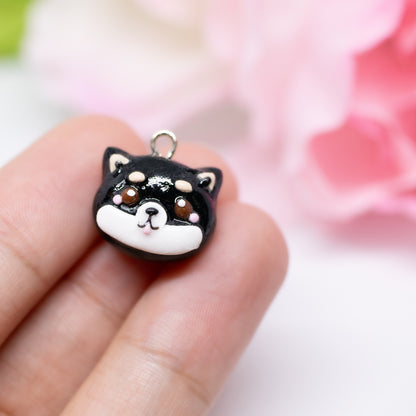 Handmade polymer clay shiba inu charms. Available in two colors: black and tan. Use as a charm or as a pair of earrings.