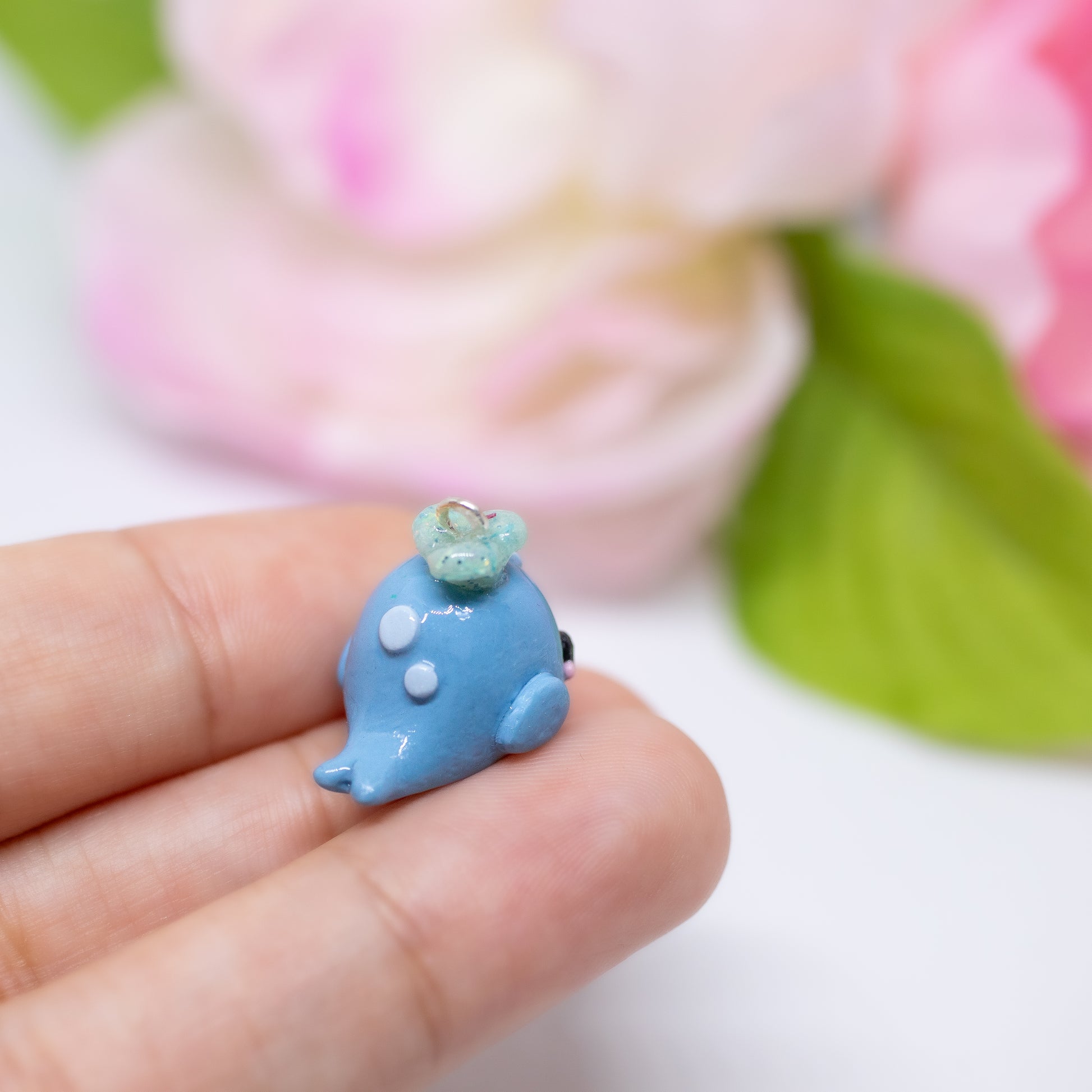 Handmade polymer clay blue whale charms. Available as a pair of earrings or as a charm. This little blue whale has spots on it's forehead and a glittery water splash coming out of its head.