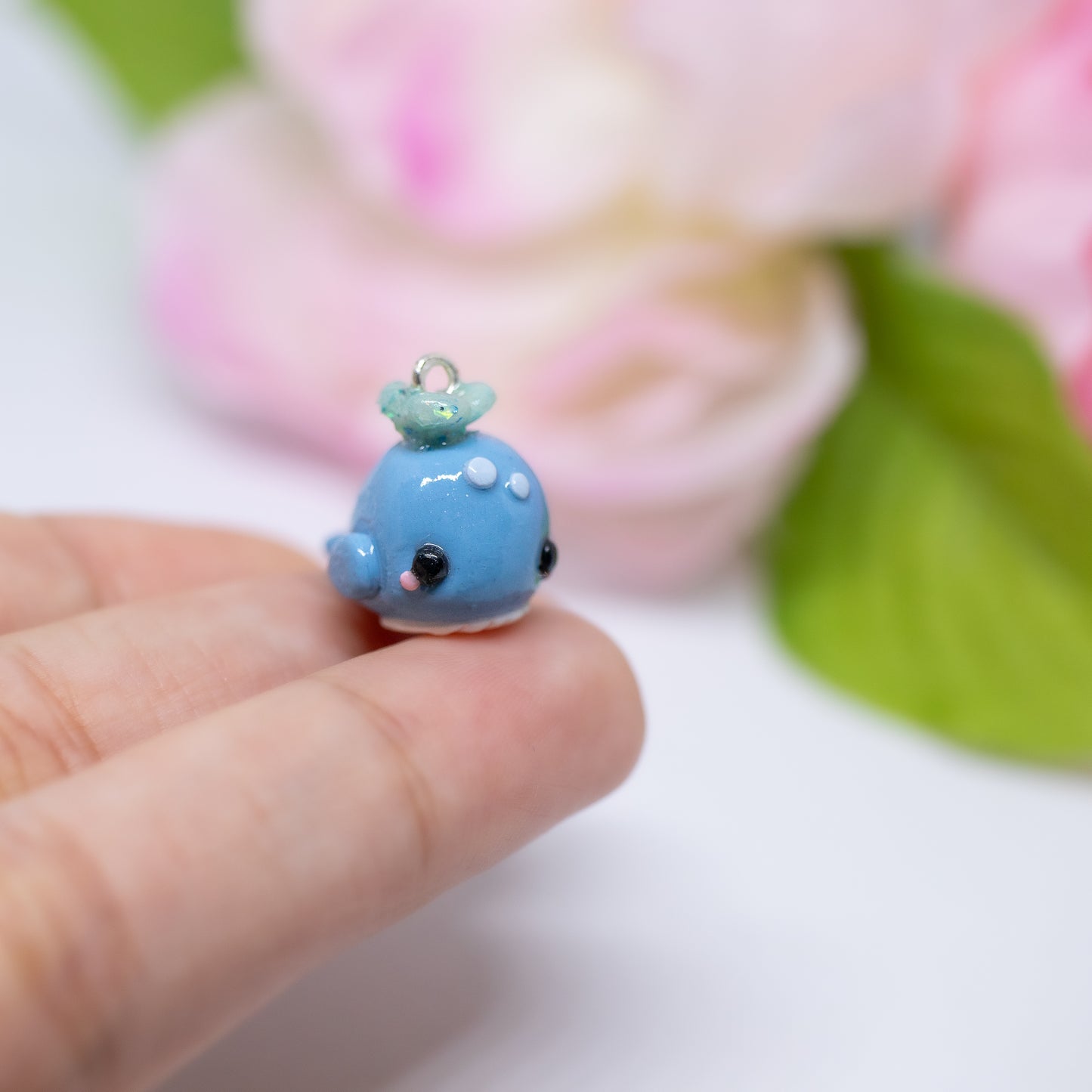 Handmade polymer clay blue whale charms. Available as a pair of earrings or as a charm. This little blue whale has spots on it's forehead and a glittery water splash coming out of its head.