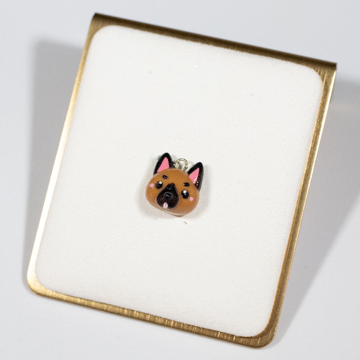 Cute and simple German shepherd charms! 🐾 These little charms have blushing cheeks and a tongue that sticks out. Size: 0.625” tall x 0.5” wide