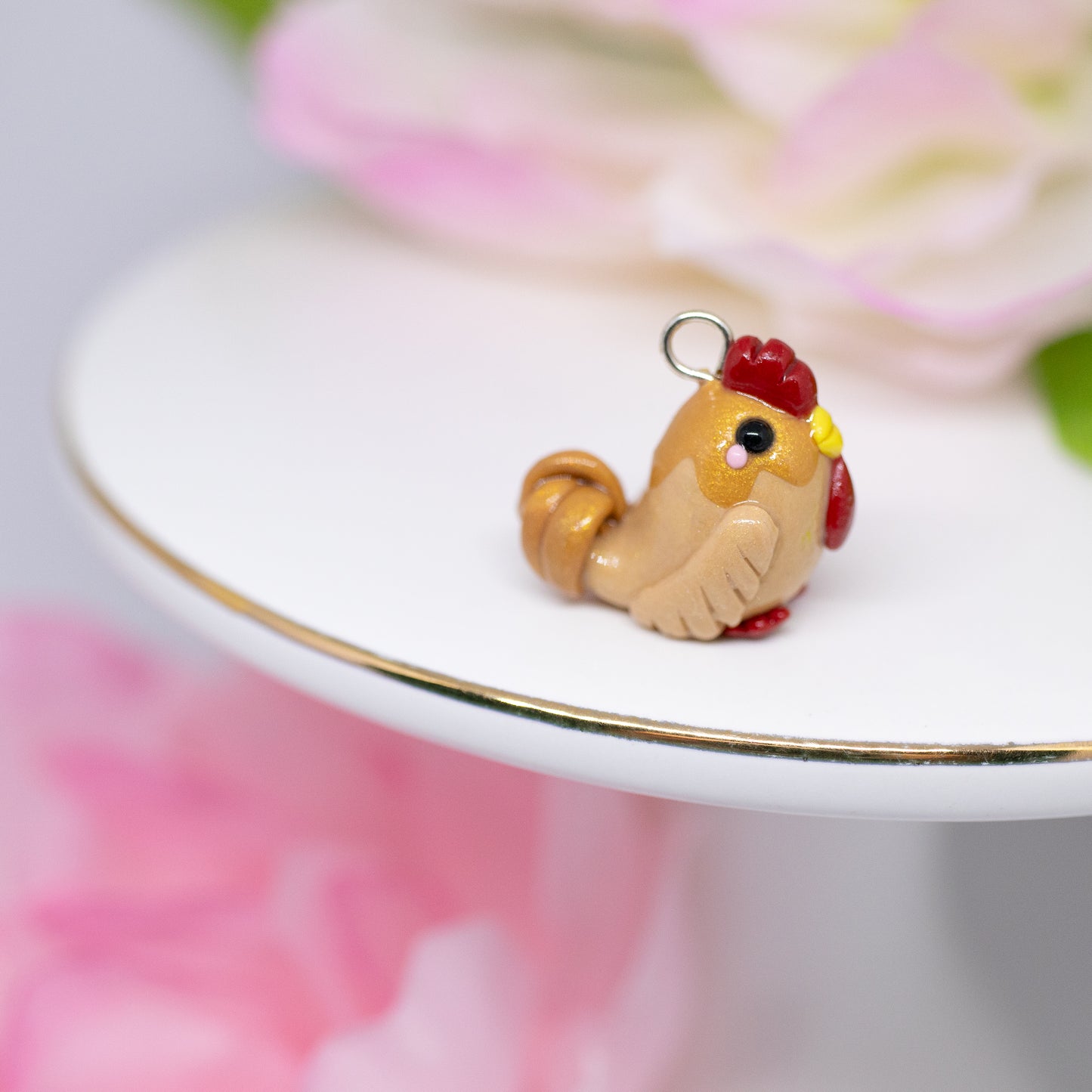 A cute, chubby gold rooster charm. It has a little comb and yellow beak. This charm can be attached to a cell phone, purse, pouch, stitch marker, earrings, and more!