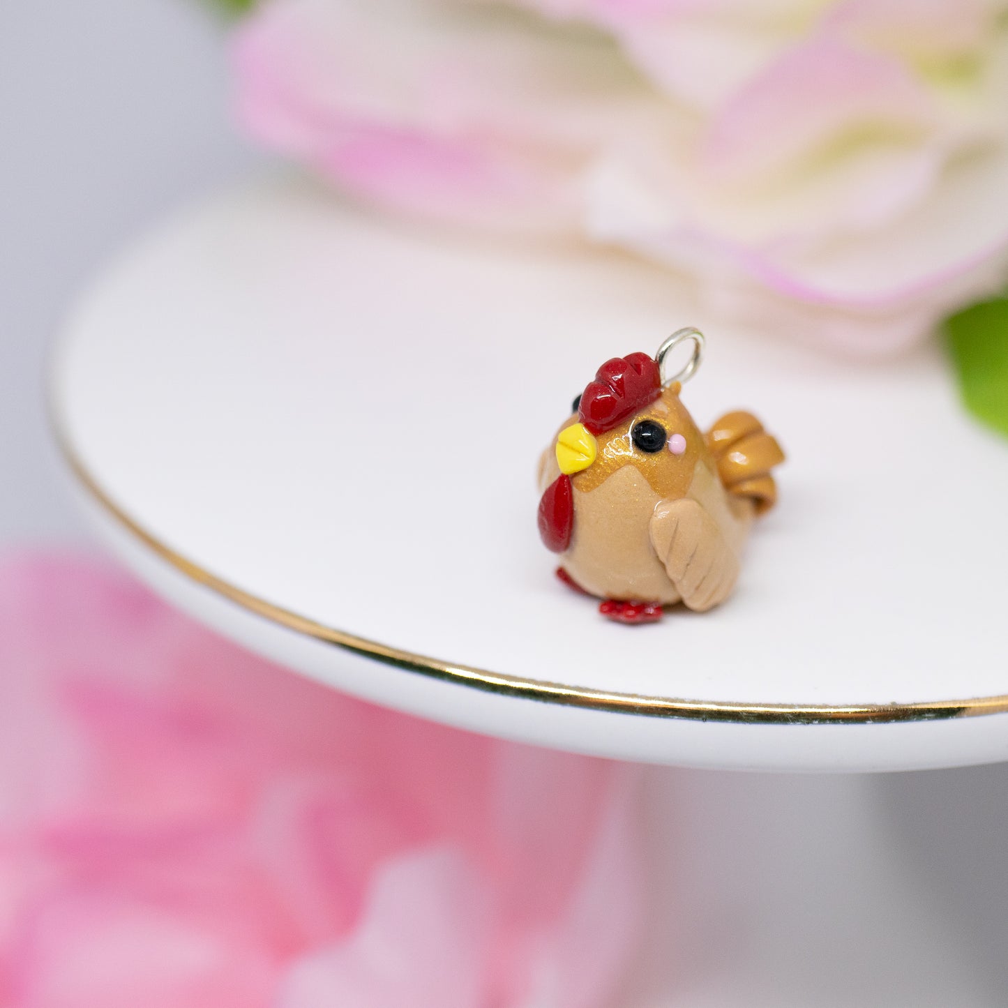 A cute, chubby gold rooster charm. It has a little comb and yellow beak. This charm can be attached to a cell phone, purse, pouch, stitch marker, earrings, and more!