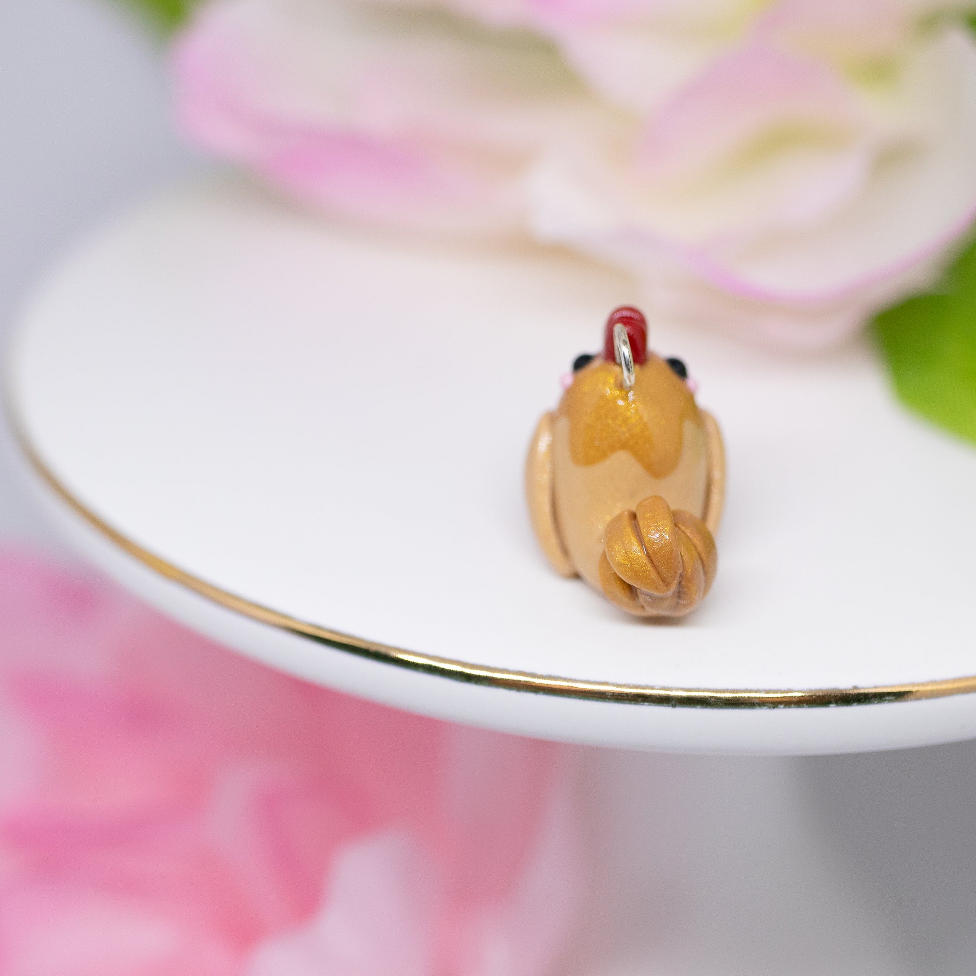 A cute, chubby gold rooster charm. It has a little comb and yellow beak. This charm can be attached to a cell phone, purse, pouch, stitch marker, earrings, and more!