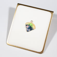 Load image into Gallery viewer, A simple alien pizza charm. This little charm has a tiny, green alien tucked inside a pizza. The pizza is galaxy-themed, with little planets, stars and glitter. This charm can be attached onto a cellphone, planner or purse!
