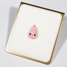Load image into Gallery viewer, A cute and simple pink bunny charm. This bunny has a small sakura flower and leaf on her head. This bunny has little eyelashes and large, pink ears.This little charm can be hung from a cellphone, planner, or purse!
