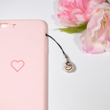 A simple cinnamon roll charm. This little charm has icing on top and is dusted with chalk pastels for a baked look. This charm can be attached onto a cellphone, planner or purse!