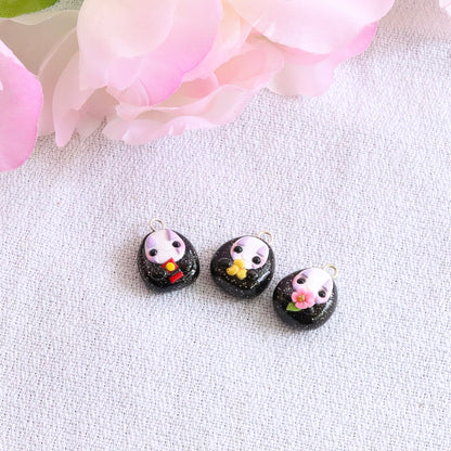 Handmade polymer clay no face charms inspired by the movie spirited away. This listing is for one charm, available in three styles: cherry blossom flower, red bath token, or gold coin.