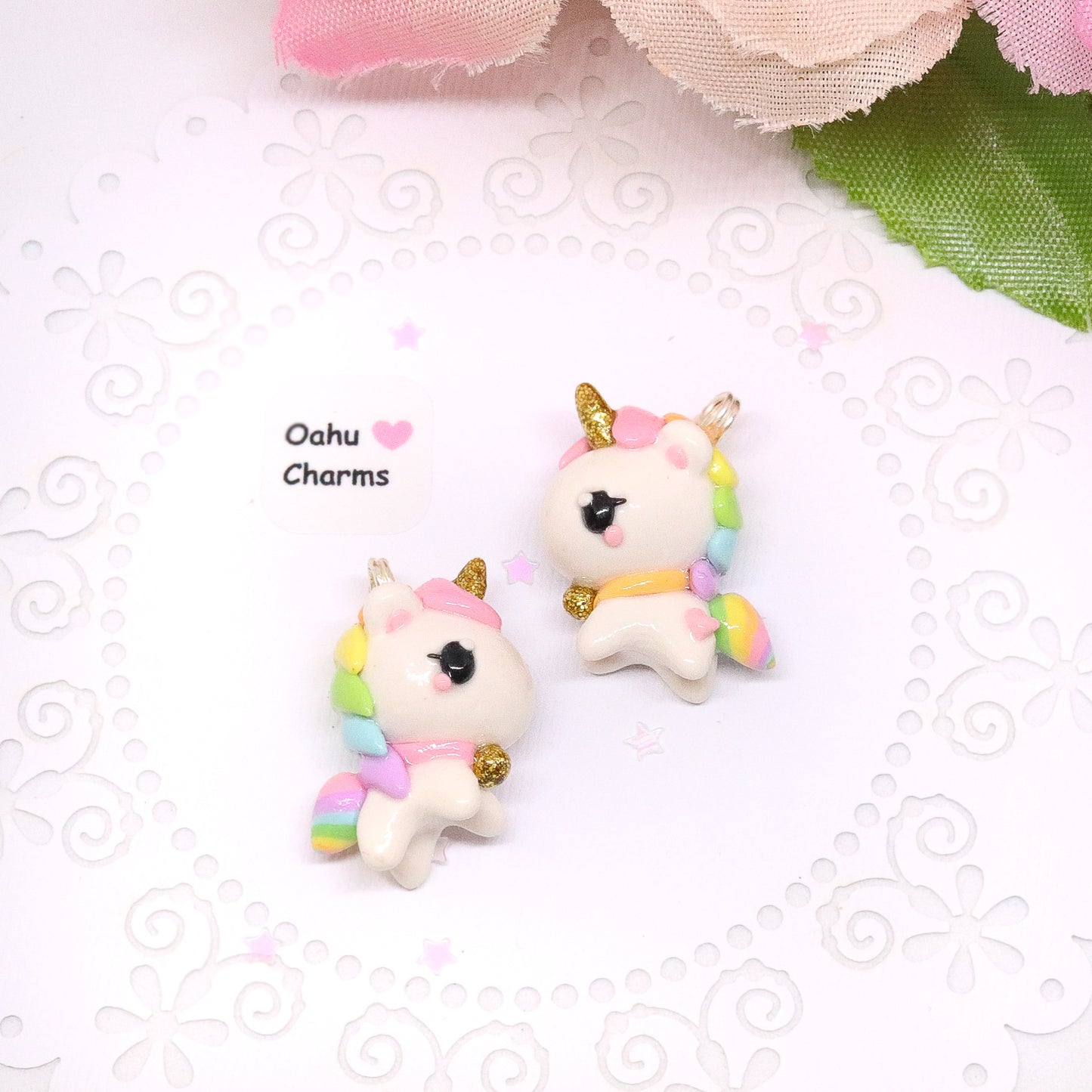 A chubby, rainbow unicorn with a gold bell and unicorn horn.  They can be used as phone charms, earrings or planner charms!