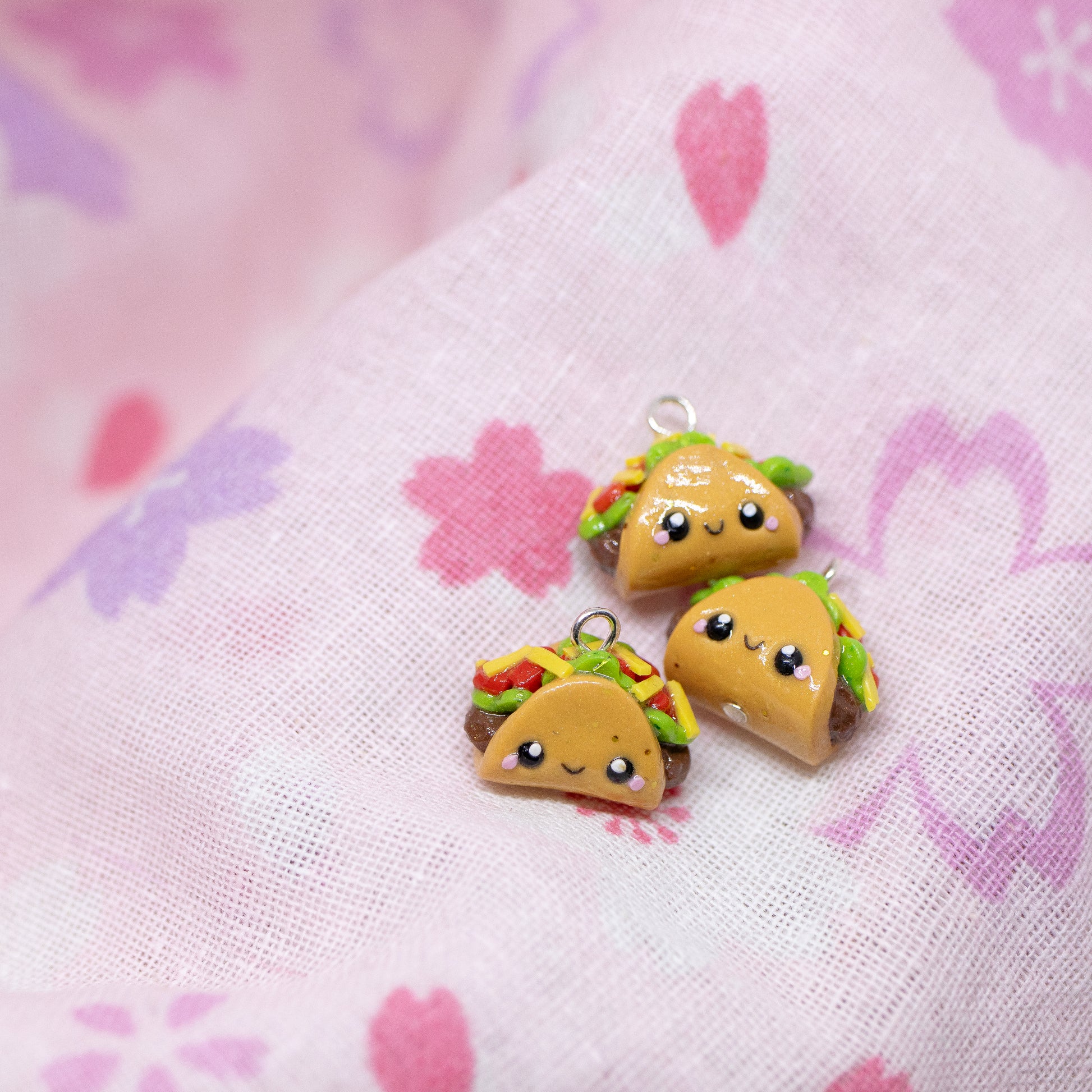 Handmade polymer clay taco charms. Available as a phone charm or pair of earrings. This little taco has a cute smiling face with a lot of toppings like tomatio, cheese and lettuce.