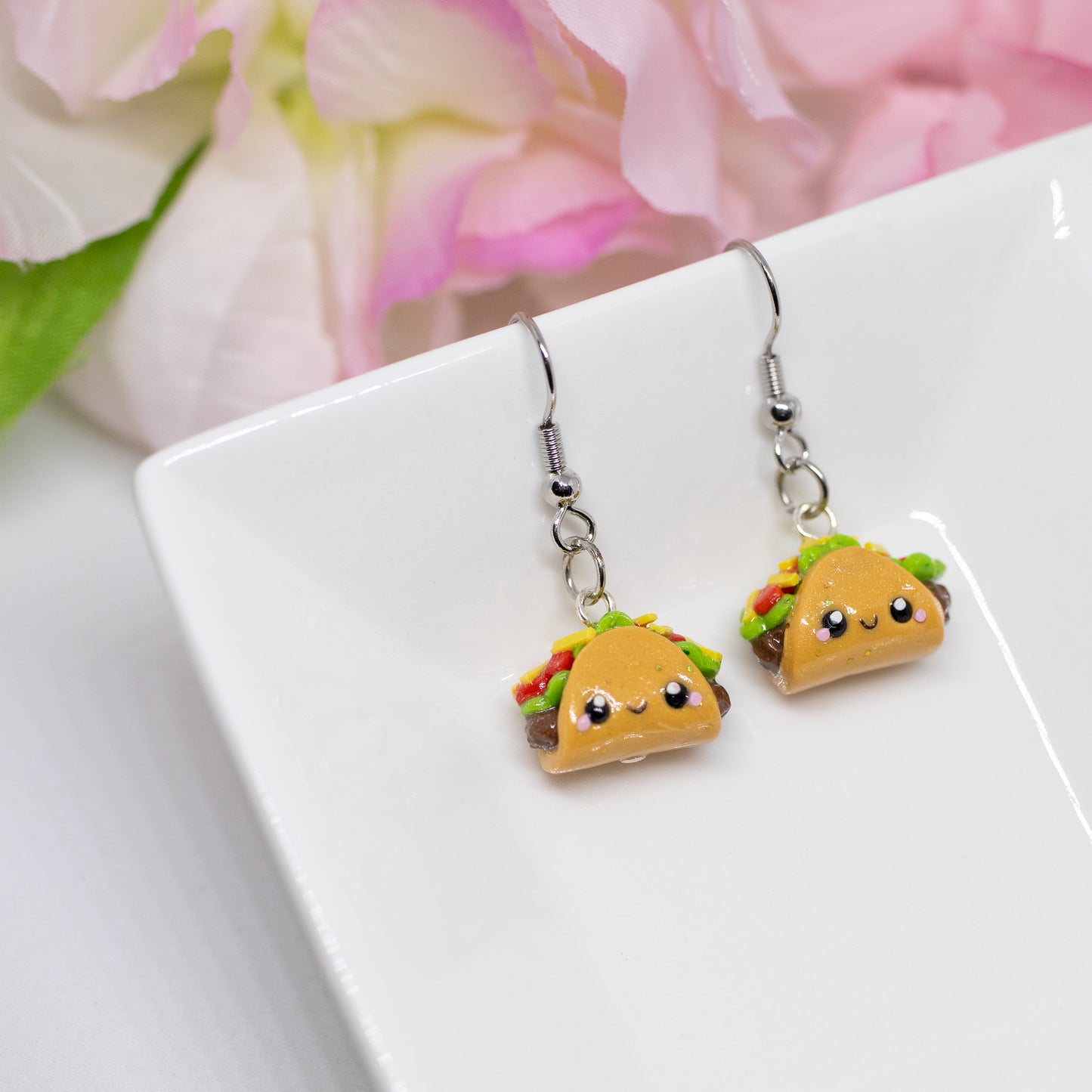 Handmade polymer clay taco charms. Available as a phone charm or pair of earrings. This little taco has a cute smiling face with a lot of toppings like tomatio, cheese and lettuce.