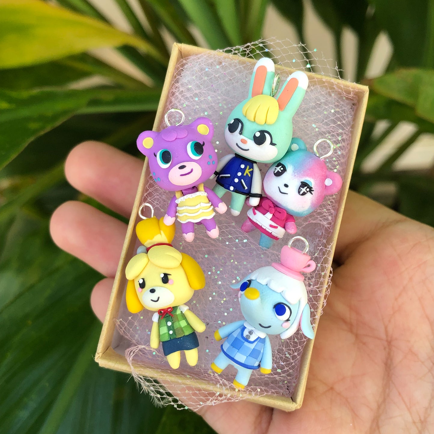 Adorable and tiny animal cossing villager charms. There's5 villager charms in this photo.