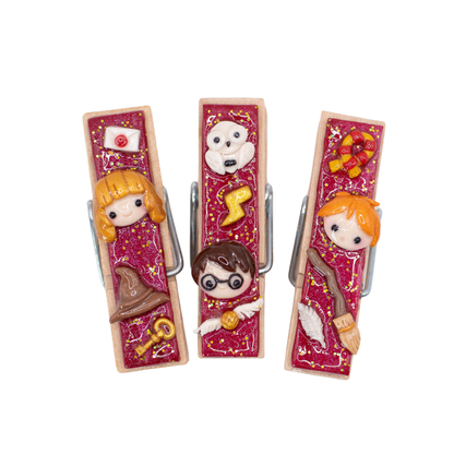 Three decorative clothespins with Harry Potter inspired details on a white background.