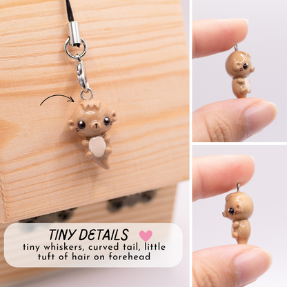 This picture is a collage of 3 images; each one showing a different angle of a otter polymer clay charm. The text on this image says "Tiny Details: tiny whiskers, curved tail, little tuft of hair on forehead"