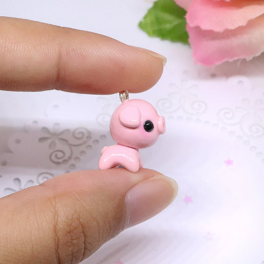 A cute, chubby pig charm. This charm has a lot of tiny details, including a snout and curly tail. Size: 0.75" wide x 0.75" tall