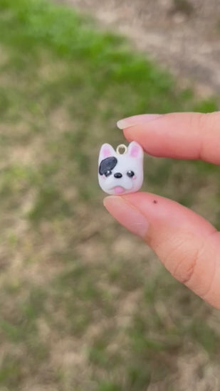 A quick show of the black and white frenchie clay charm in the sunlight.