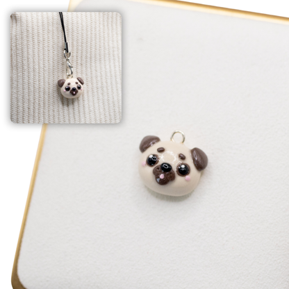 A picture of a pug polymer clay dog charm against a white background, with a 2nd smaller photo of the same dog charm being hung with a phone strap against a textured background.