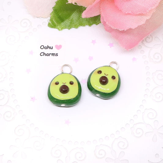 An avocado clay charm. This charm has a lot of tiny clay details, including a happy face and avocado seed in the middle. 