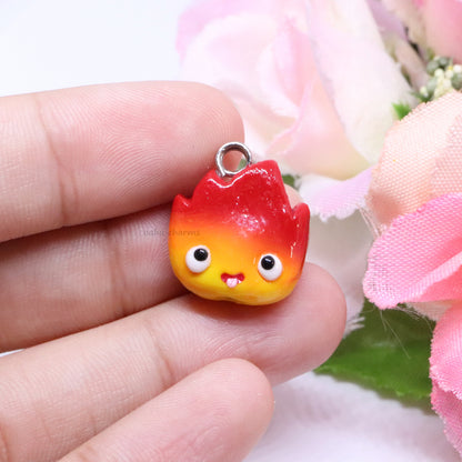 A cute, chubby calcifer charm inspired by the movie, Howl's Moving Castle. This little charm has a cute smile, and tiny pink blush. Handmade from polymer clay.